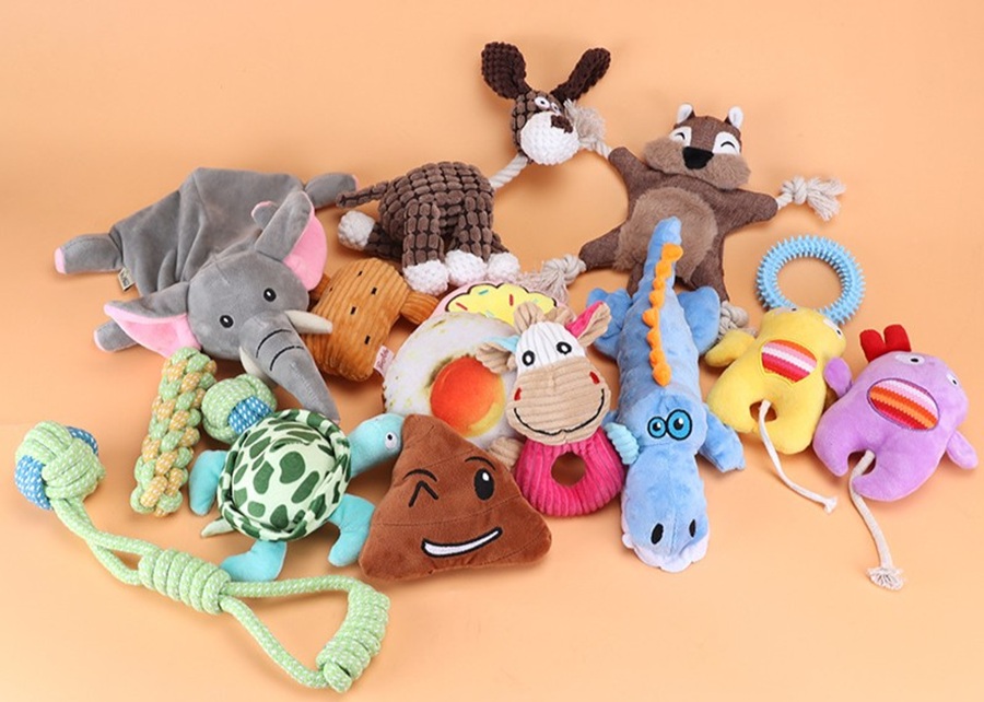 A variety of puppy boredom toys on a clean background