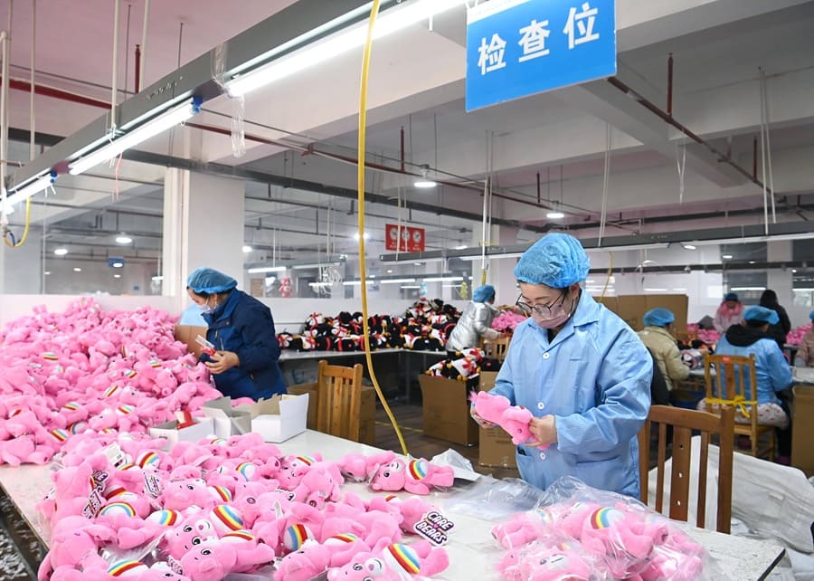 A quality control inspector checking a pet toy for safety and durability in a lab setting.