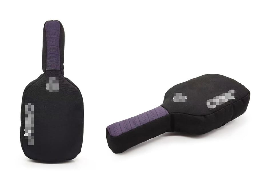 a plush dog toy shaped like a pickleball paddle next to a real one