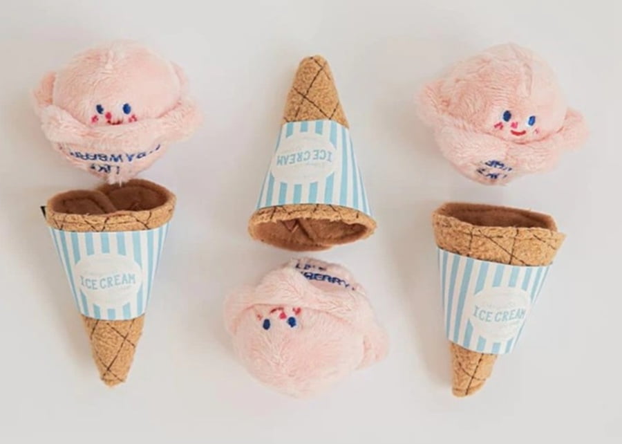 A fluffy white dog with a torn plush toy, showcasing Preeminent's durable ODM manufacturing.