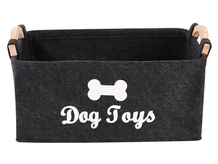 Grey felt storage bin with wooden handles for dog toys