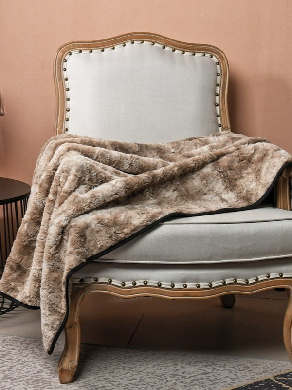 Premium pet blanket draped over modern furniture in a stylish living room