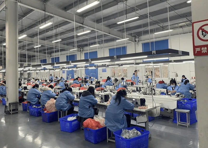 Plush Dog Toy Manufacturers Production Process Factory floor scene showing workers sewing and inspecting plush toys
