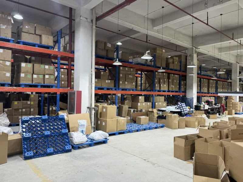 Warehouse and packing area with boxed pet home product inventory