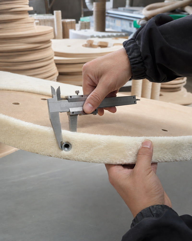 Cat tree platform hardware and edge finish being checked with a vernier caliper