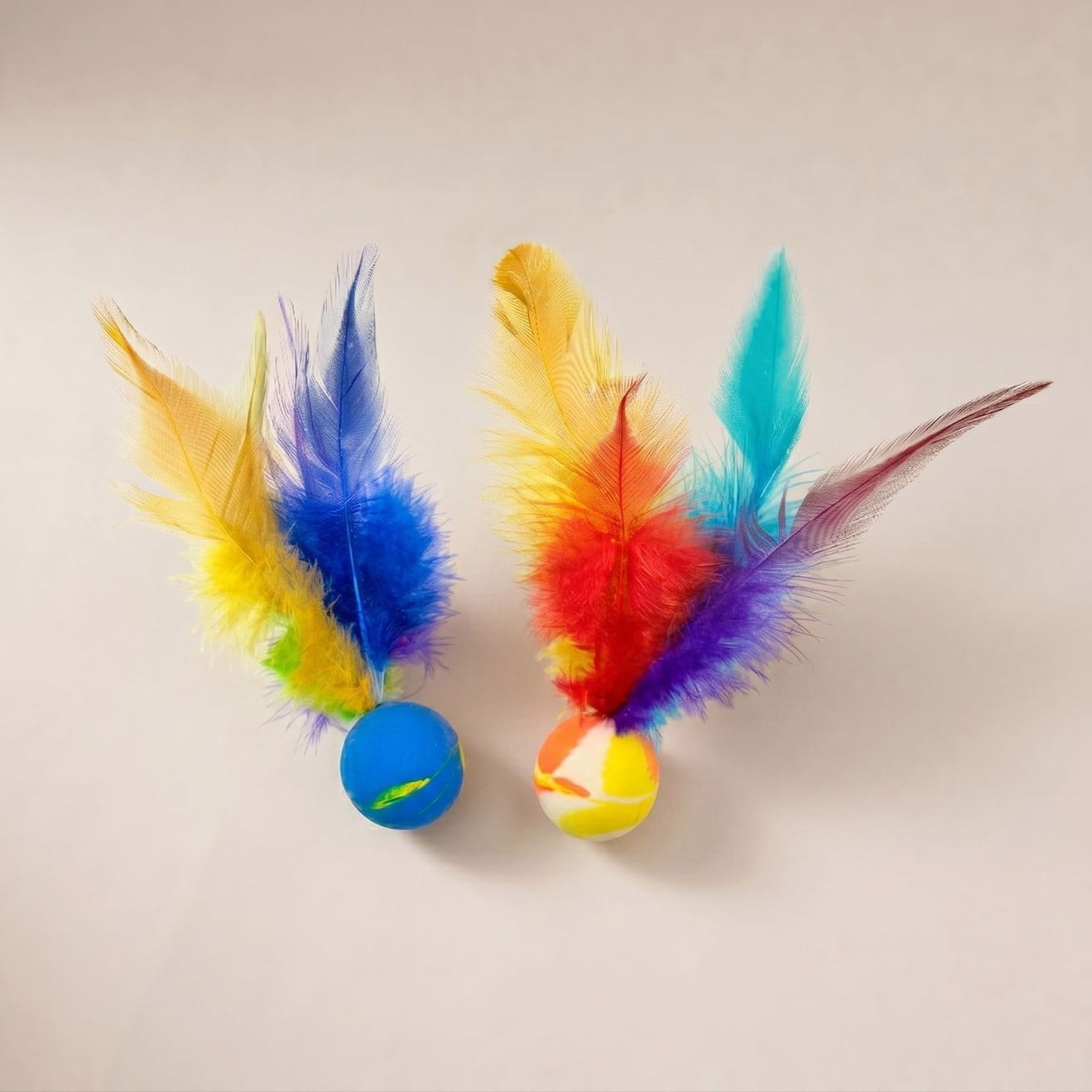 Cat ball toys with feathers and faux-fur tails