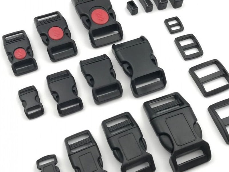 Black plastic buckles, strap adjusters and webbing loops for dog collars and harnesses.