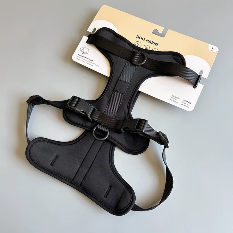 Black pet harness attached to a printed retail display card with a hanging slot and size information.