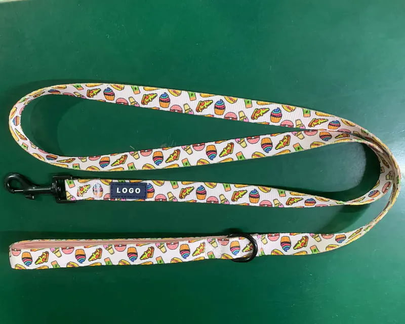 Printed dog leash with a blue rubber logo label near the snap hook for private label customization