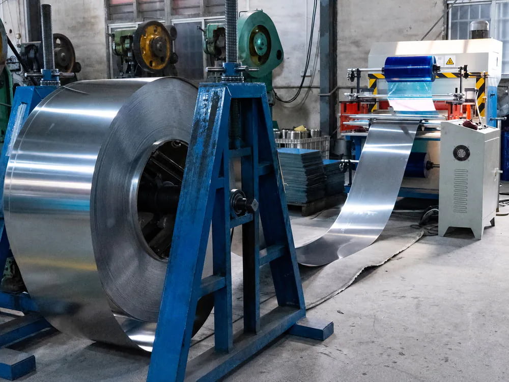 Stainless steel coil feeding into processing equipment for bowl production
