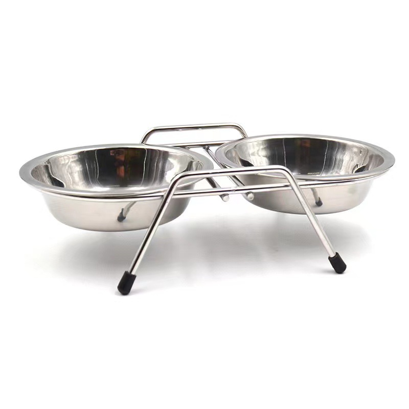 Two stainless steel pet bowls in a raised metal stand